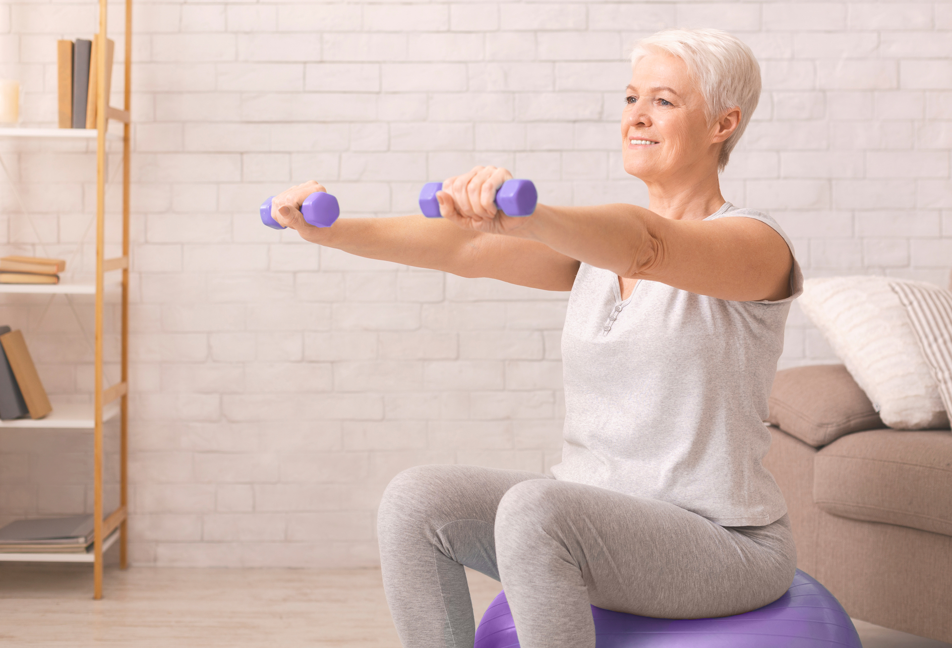 Woman Doing Exercises on Exercise Ball with Dumbbells